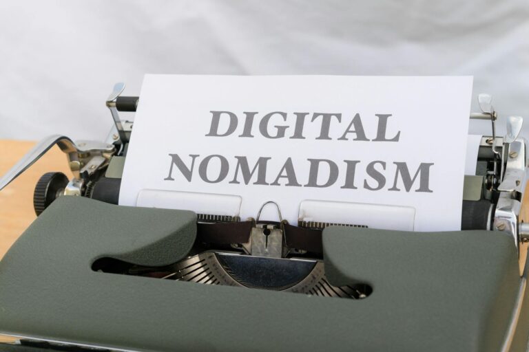 A vintage typewriter displaying the text 'Digital Nomadism,' symbolizing the modern remote work trend.